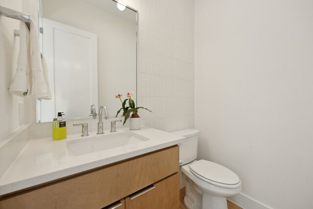 bathroom featuring toilet and vanity