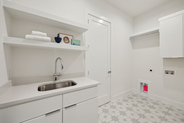 laundry room featuring hookup for a washing machine, sink, cabinets, and hookup for an electric dryer