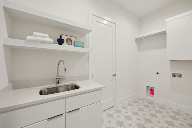 laundry area featuring washer hookup, a sink, cabinet space, light floors, and electric dryer hookup