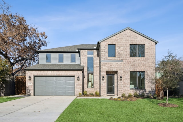 view of front of house with concrete driveway, brick siding, a front lawn, and an attached garage