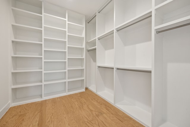 walk in closet featuring light wood-style flooring