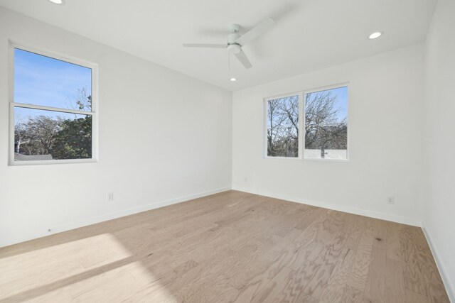 unfurnished room featuring light wood-type flooring, ceiling fan, and a wealth of natural light