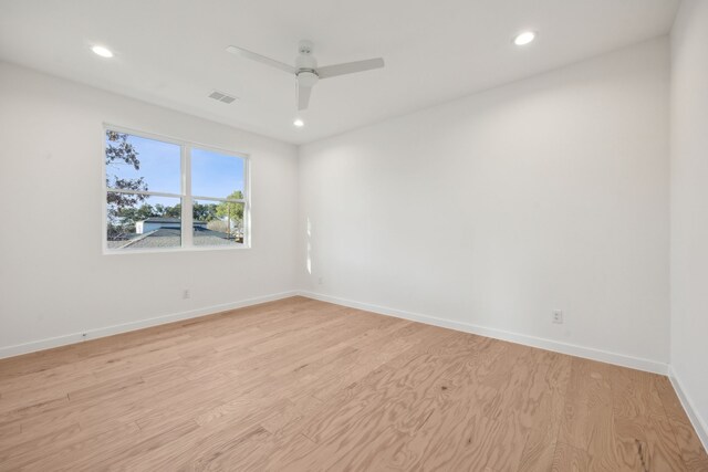 spare room featuring light hardwood / wood-style floors and ceiling fan