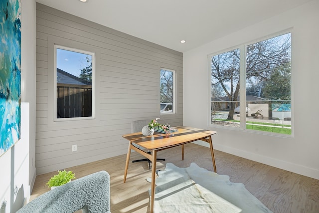 office featuring recessed lighting, wooden walls, baseboards, and wood finished floors