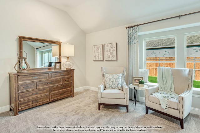 sitting room featuring light colored carpet and vaulted ceiling