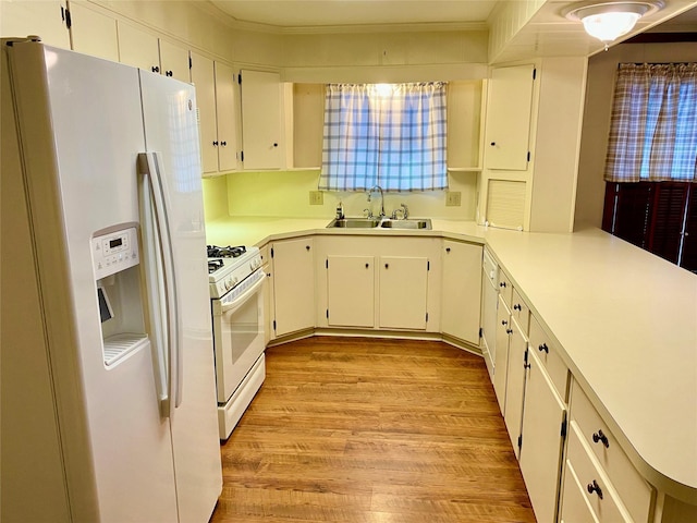 kitchen featuring white appliances, white cabinetry, sink, light wood-type flooring, and kitchen peninsula