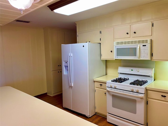 kitchen featuring white appliances and dark wood-type flooring