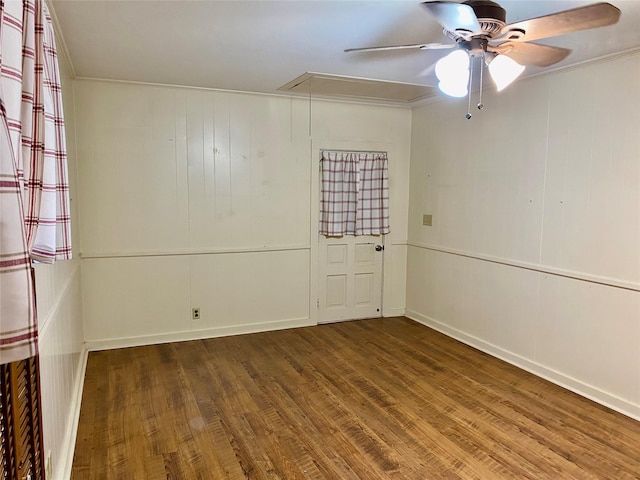 empty room with hardwood / wood-style flooring, crown molding, and ceiling fan