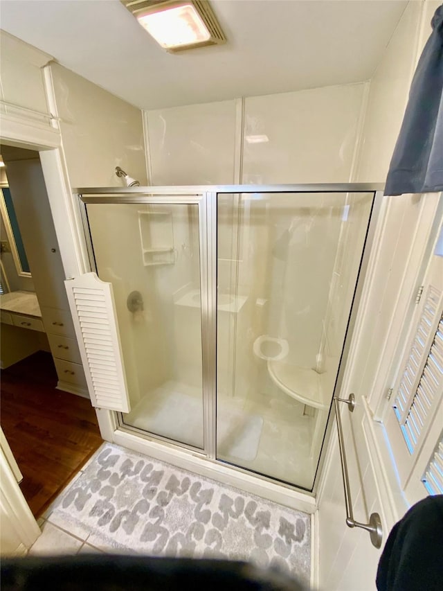 bathroom with walk in shower and tile patterned floors