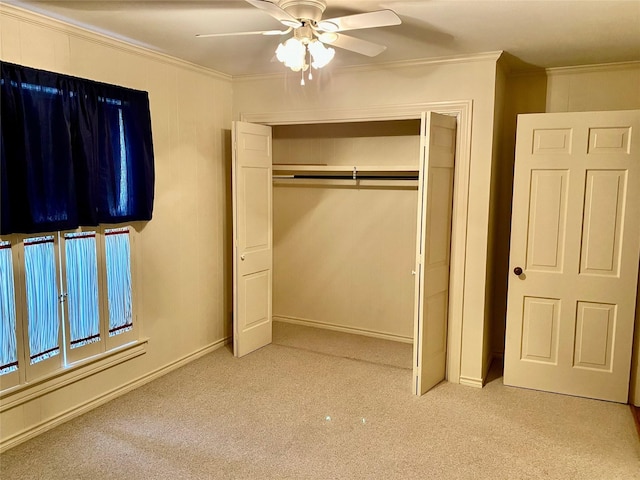 unfurnished bedroom with ceiling fan, a closet, light carpet, and ornamental molding