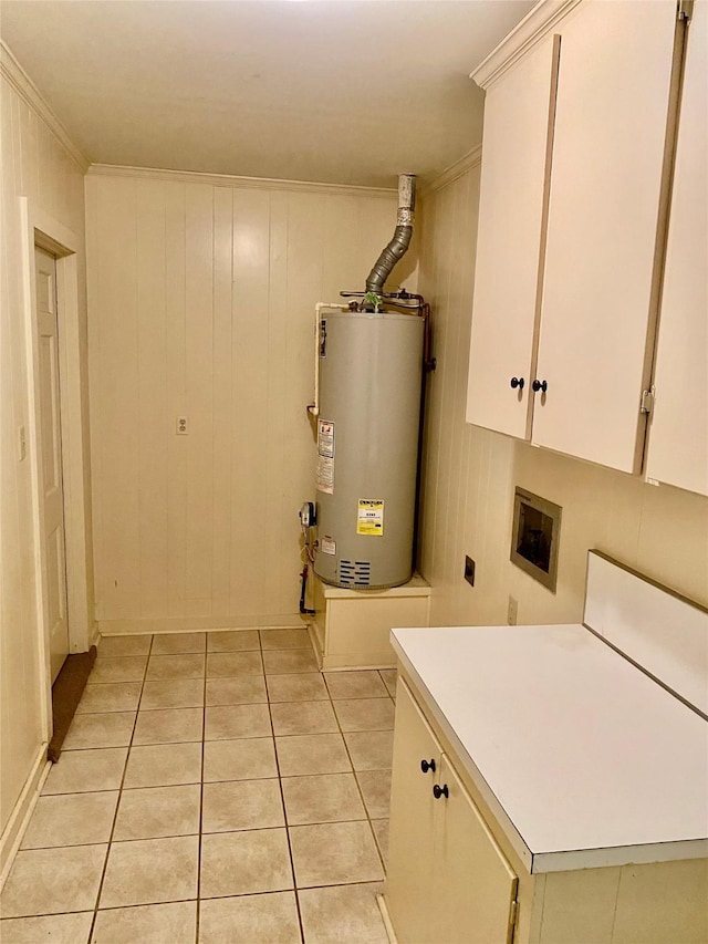 washroom with wood walls, cabinets, gas water heater, and electric dryer hookup