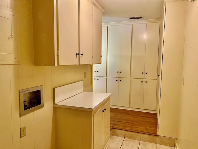 kitchen featuring white cabinets and light tile patterned floors