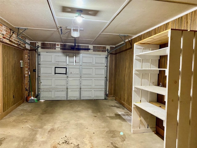 garage featuring wood walls and a garage door opener