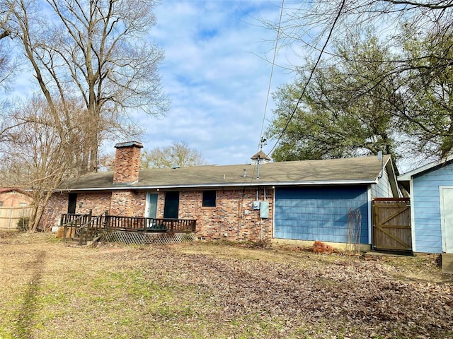 back of house with a yard and a deck