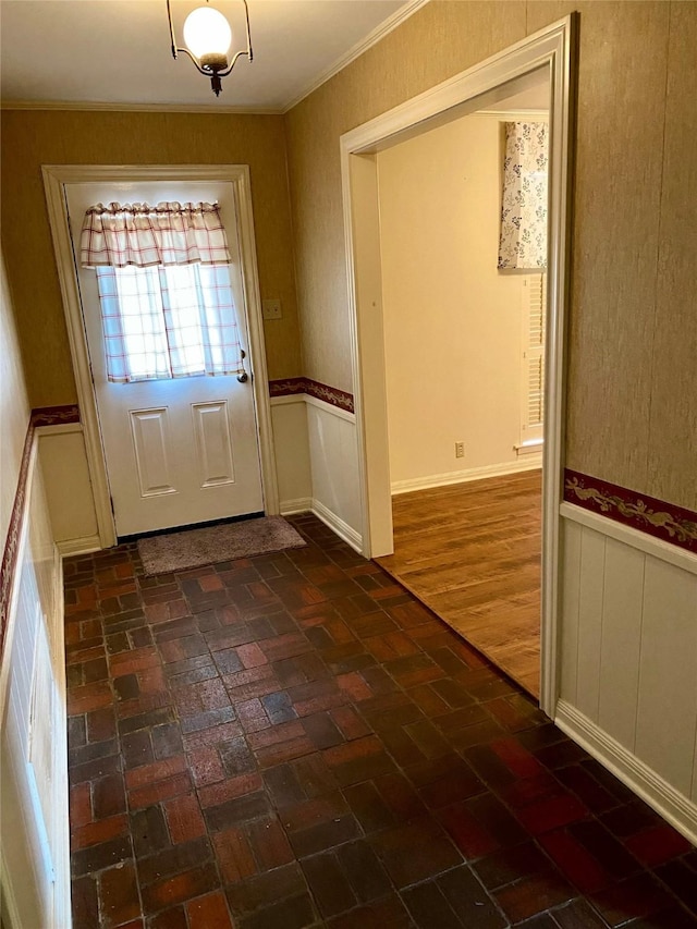 doorway to outside with crown molding