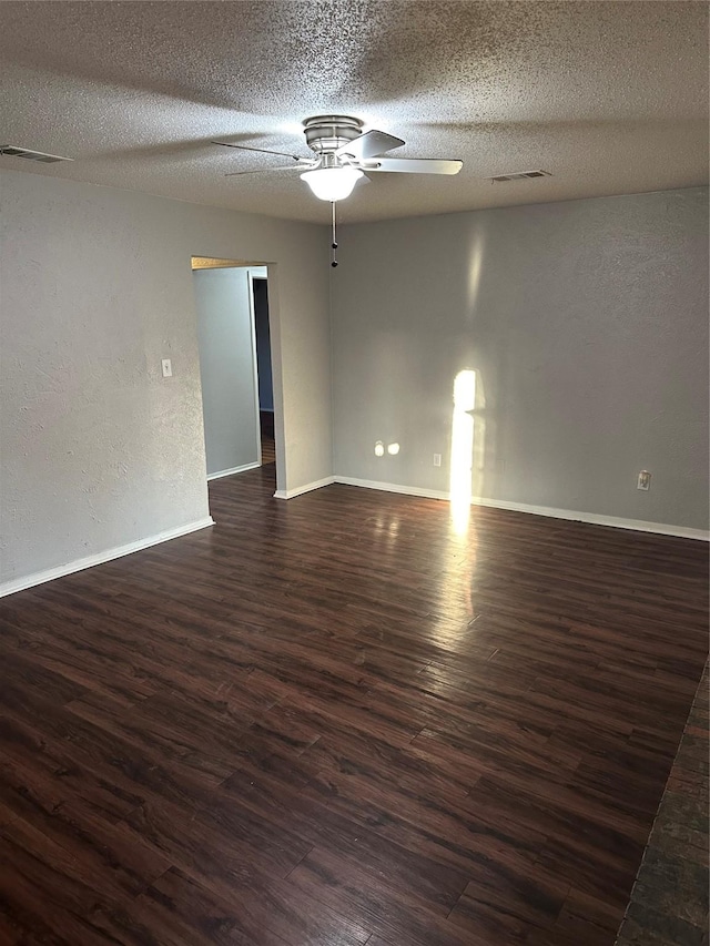 unfurnished room featuring a textured ceiling, dark hardwood / wood-style floors, and ceiling fan