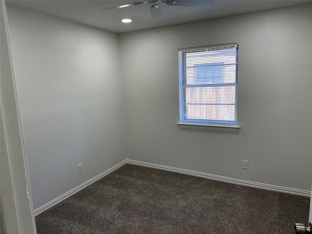 carpeted spare room with ceiling fan