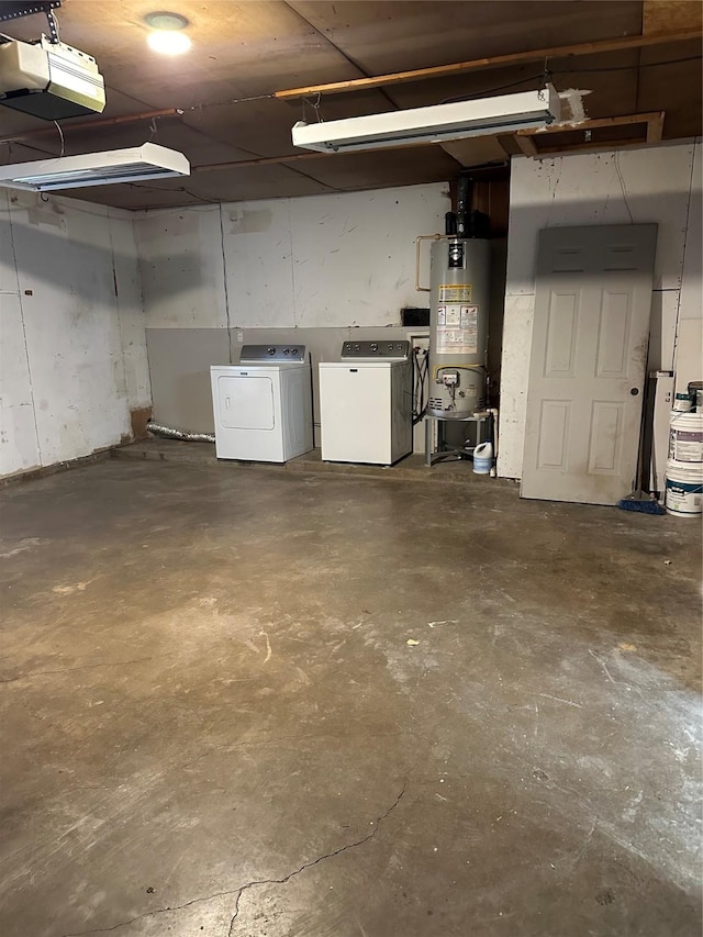 garage featuring a garage door opener, separate washer and dryer, and gas water heater