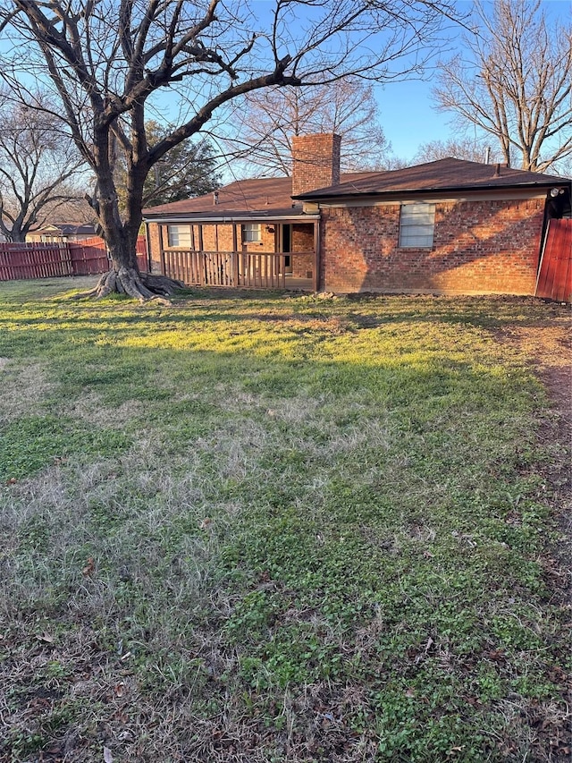 rear view of house with a lawn