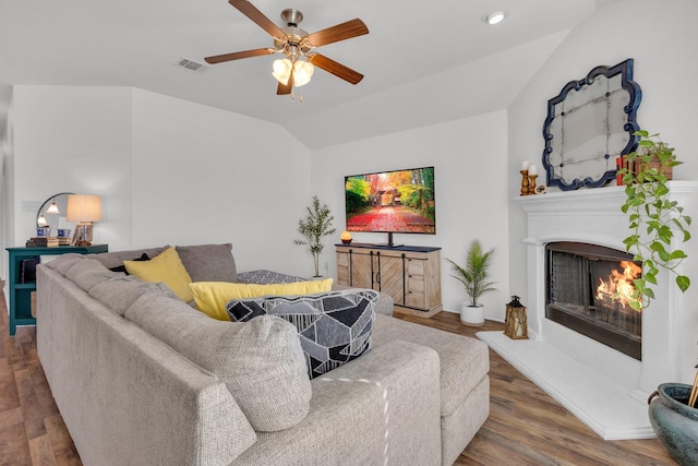 living room featuring vaulted ceiling, ceiling fan, and hardwood / wood-style floors