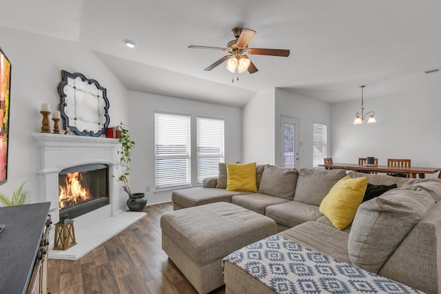 living room featuring ceiling fan with notable chandelier, dark hardwood / wood-style floors, lofted ceiling, and a healthy amount of sunlight