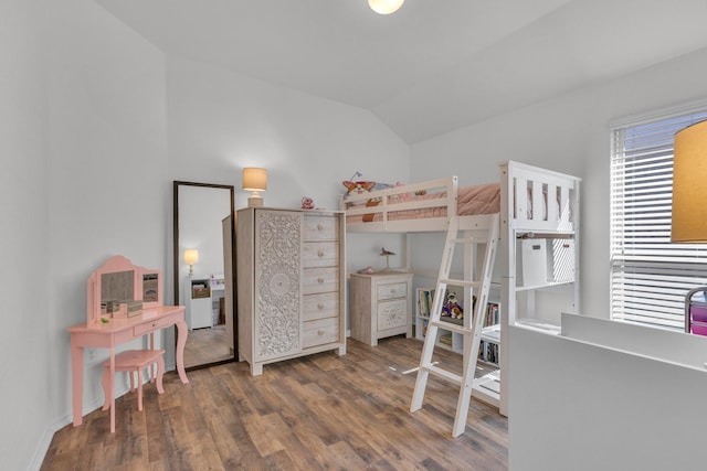 bedroom with dark hardwood / wood-style floors and vaulted ceiling