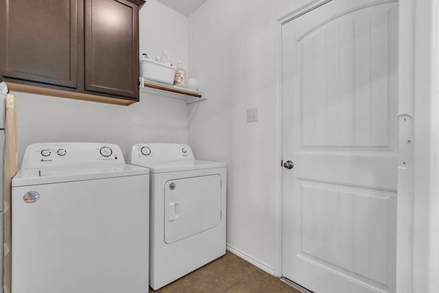 laundry area with cabinets, tile patterned floors, and washing machine and dryer