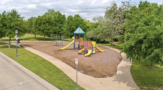 view of playground with a lawn