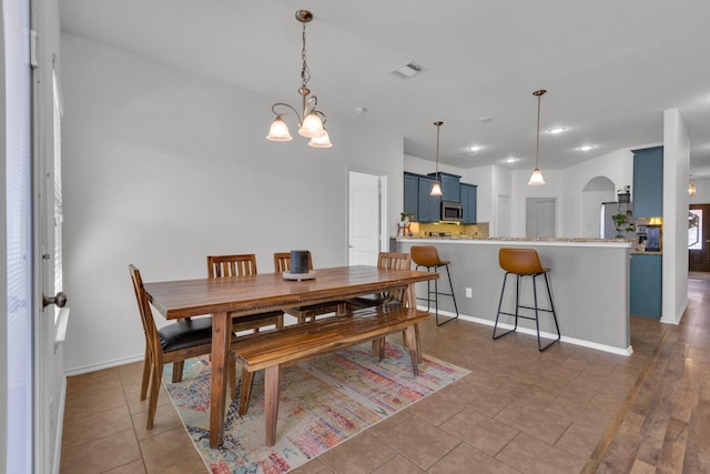 dining space featuring light tile patterned flooring