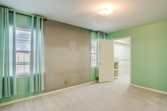 unfurnished room featuring light colored carpet