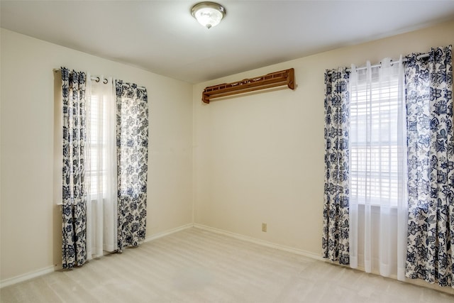 empty room featuring carpet flooring and a healthy amount of sunlight