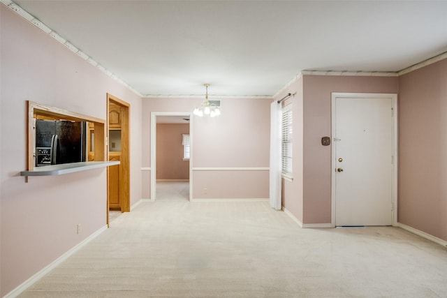 interior space with light colored carpet and a notable chandelier