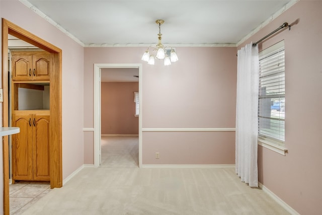 unfurnished dining area featuring light carpet, a notable chandelier, and crown molding