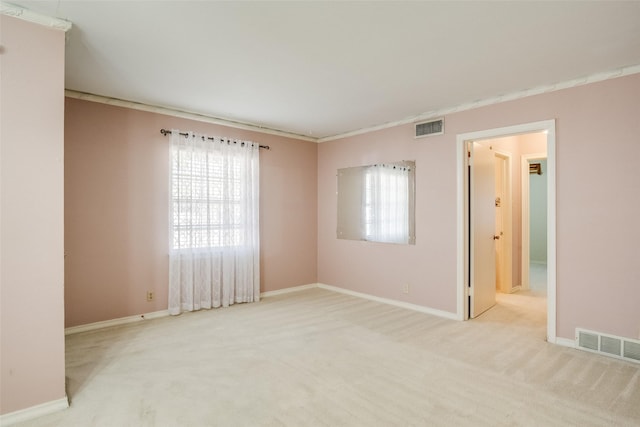 spare room featuring light colored carpet