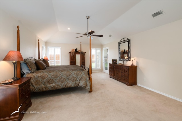 carpeted bedroom featuring lofted ceiling, multiple windows, and ceiling fan