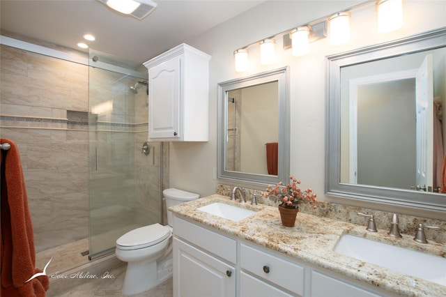 bathroom featuring toilet, tile patterned flooring, an enclosed shower, and vanity