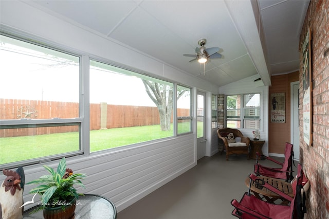 sunroom / solarium with lofted ceiling and ceiling fan