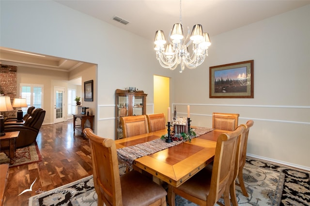 dining room featuring an inviting chandelier and dark hardwood / wood-style flooring