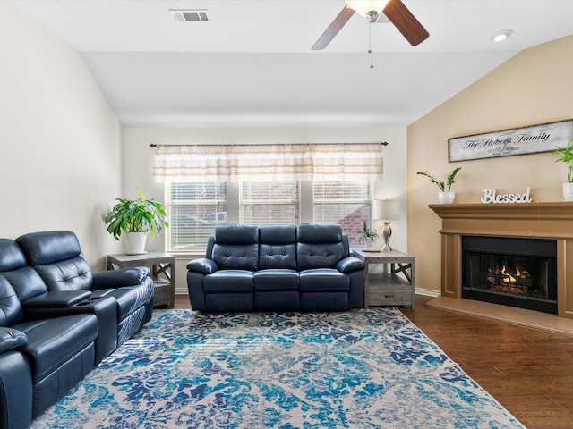 living room featuring ceiling fan, dark hardwood / wood-style flooring, and vaulted ceiling