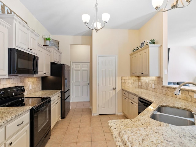 kitchen featuring black appliances, a chandelier, light tile patterned floors, sink, and decorative light fixtures