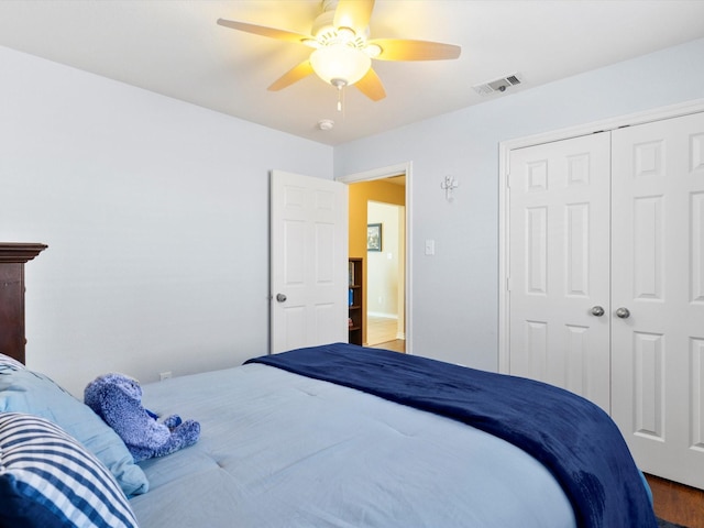 bedroom with hardwood / wood-style flooring, a closet, and ceiling fan