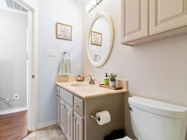 bathroom featuring vanity, toilet, and tile patterned flooring