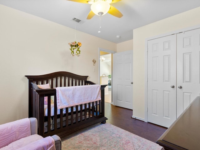 bedroom featuring a closet, ceiling fan, and dark wood-type flooring