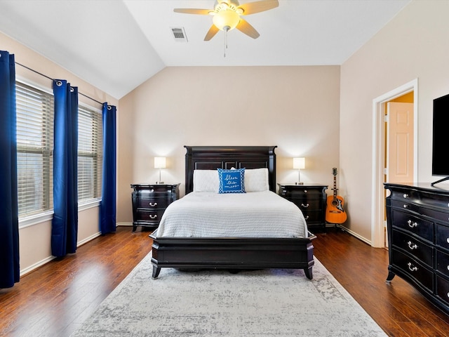 bedroom with ceiling fan, dark wood-type flooring, and lofted ceiling