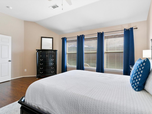 bedroom featuring ceiling fan, dark hardwood / wood-style flooring, and lofted ceiling