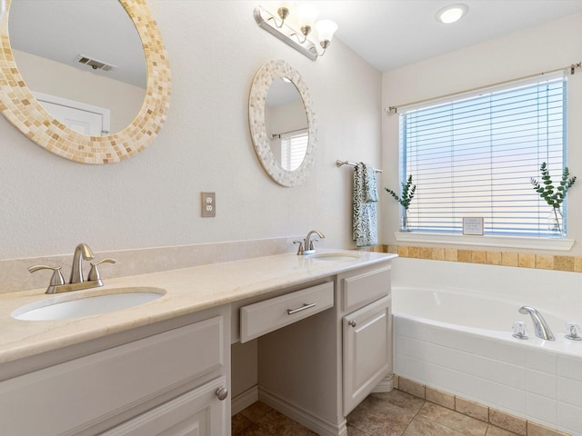 bathroom with vanity, a bathtub, and tile patterned flooring