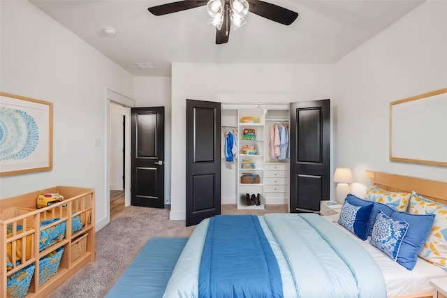 carpeted bedroom with ceiling fan and a closet