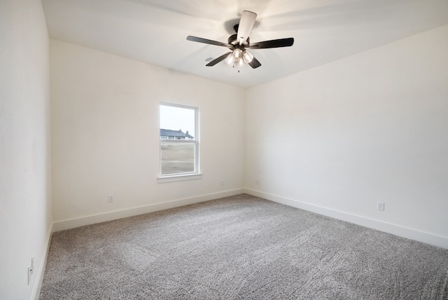 empty room with ceiling fan and carpet flooring