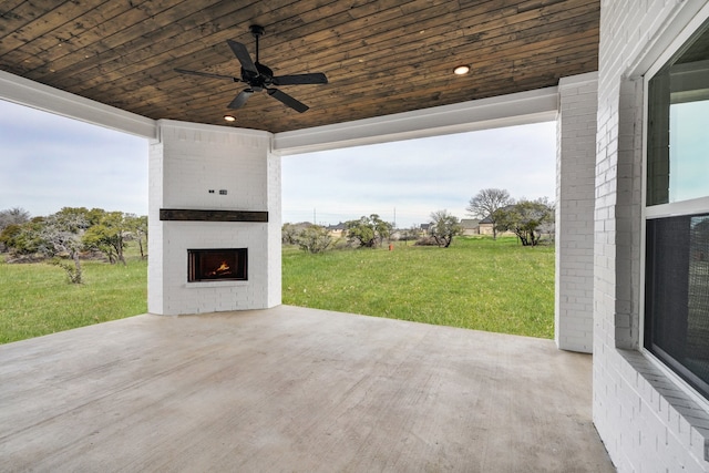 view of patio / terrace with an outdoor brick fireplace and ceiling fan