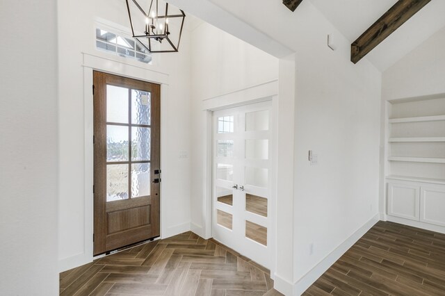 entryway with vaulted ceiling with beams and a notable chandelier